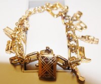 Lot 638 - A ladies Burberry silver gilt charm bracelet...