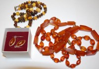 Lot 524 - Two faux amber necklaces; a beaded...