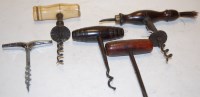 Lot 591 - A 19th century steel corkscrew with turned...