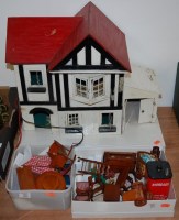 Lot 820 - A 1970s child's painted wooden dolls house in...