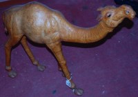 Lot 846 - A leather clad figure of a camel