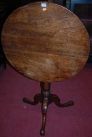 Lot 1101 - A circa 1800 provincial oak circular tilt top...