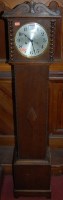 Lot 1107 - A 1930s moulded oak grandmother clock having a...
