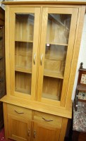 Lot 1115 - A contemporary light oak bookcase cupboard...