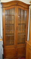 Lot 1116 - A 1920s moulded oak and lead glazed four door...