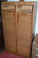 Lot 1125 - An early 20th century oak twin tambour fronted...