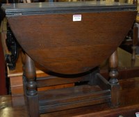 Lot 1170 - A small moulded oak drop flap occasional table