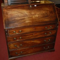Lot 1171 - A George III mahogany slopefront four drawer...