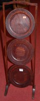 Lot 1185 - A 1930s beech three-tier circular folding cake...