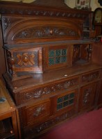 Lot 1191 - A late 19th century heavily carved oak dresser,...