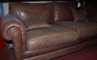 Lot 1151 - A modern tan leather three seater sofa, width...