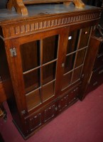 Lot 1233 - A moulded oak double door glazed bookcase,...