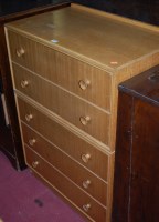 Lot 1238 - A 1960s light oak and teak ledgeback chest of...