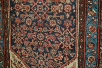 Lot 1149 - A Persian woollen blue ground rug, 210x102cm