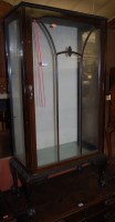 Lot 1243 - A 1930s walnut ledgeback single door glazed...