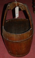 Lot 1250 - A stained elm and metal bound grain bucket