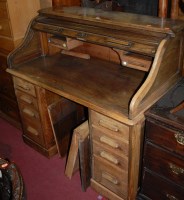Lot 1251 - A 1930s oak roll top twin pedestal kneehole...