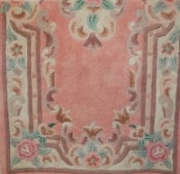 Lot 1148 - A Chinese superwash pink ground small rug,...