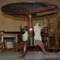 Lot 1273 - An early 19th century circular oak tilt-top...