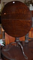 Lot 1275 - An early 19th century circular oak tilt-top...