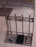 Lot 1139 - A cast metal freestanding boot-rack with...