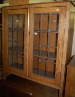 Lot 1357 - A 1930s oak and lead glazed double door...