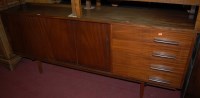 Lot 1358 - A 1960s English teak long sideboard, having...