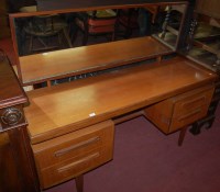 Lot 1367 - A 1960s G-Plan teak long mirrorback sideboard,...