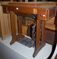 Lot 1378 - An early 20th century oak and cast iron Singer...