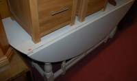 Lot 1380 - A large white painted dropleaf wake table,...