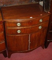 Lot 1219 - A mahogany bowfront double door side cupboard,...