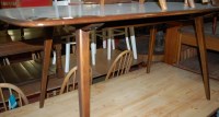 Lot 1311 - An Ercol dark elm dining table