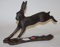 Lot 5 - A modern resin figure of a hare on a...