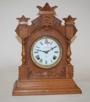 Lot 9 - A late 19th century oak cased mantel clock by...