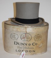 Lot 23 - An early 20th century grey top hat bearing a...