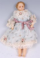 Lot 1313 - A poured wax baby girl doll, in the style of...