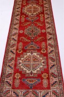 Lot 1581 - A contemporary kazak woollen rug, the red...