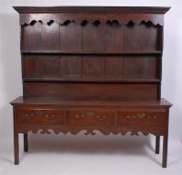 Lot 1599 - A George III oak dresser, having an associated...