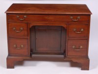 Lot 1527 - An antique mahogany kneehole desk, having an...