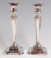 Lot 1144 - A pair of George V silver candlesticks, of...