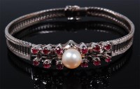 Lot 1184 - A 14ct white gold, ruby and pearl bracelet,...