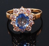 Lot 1197 - A yellow metal, sapphire and diamond cluster...
