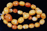 Lot 1212 - A beaded butterscotch and egg-yolk amber...