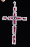 Lot 1220 - A white metal, ruby and diamond set cross...