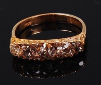Lot 1226 - An 18ct gold and diamond five stone ring, the...