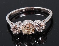 Lot 1240 - An 18ct white gold three diamond ring, the...