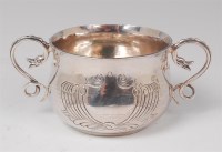 Lot 1123 - A George V hammered silver twin handled...