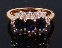 Lot 1242 - An 18ct gold, sapphire and diamond cluster...