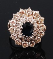 Lot 1246 - A white metal, sapphire and diamond cluster...