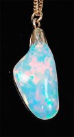 Lot 1250 - A polished opal pendant, of natural form,...